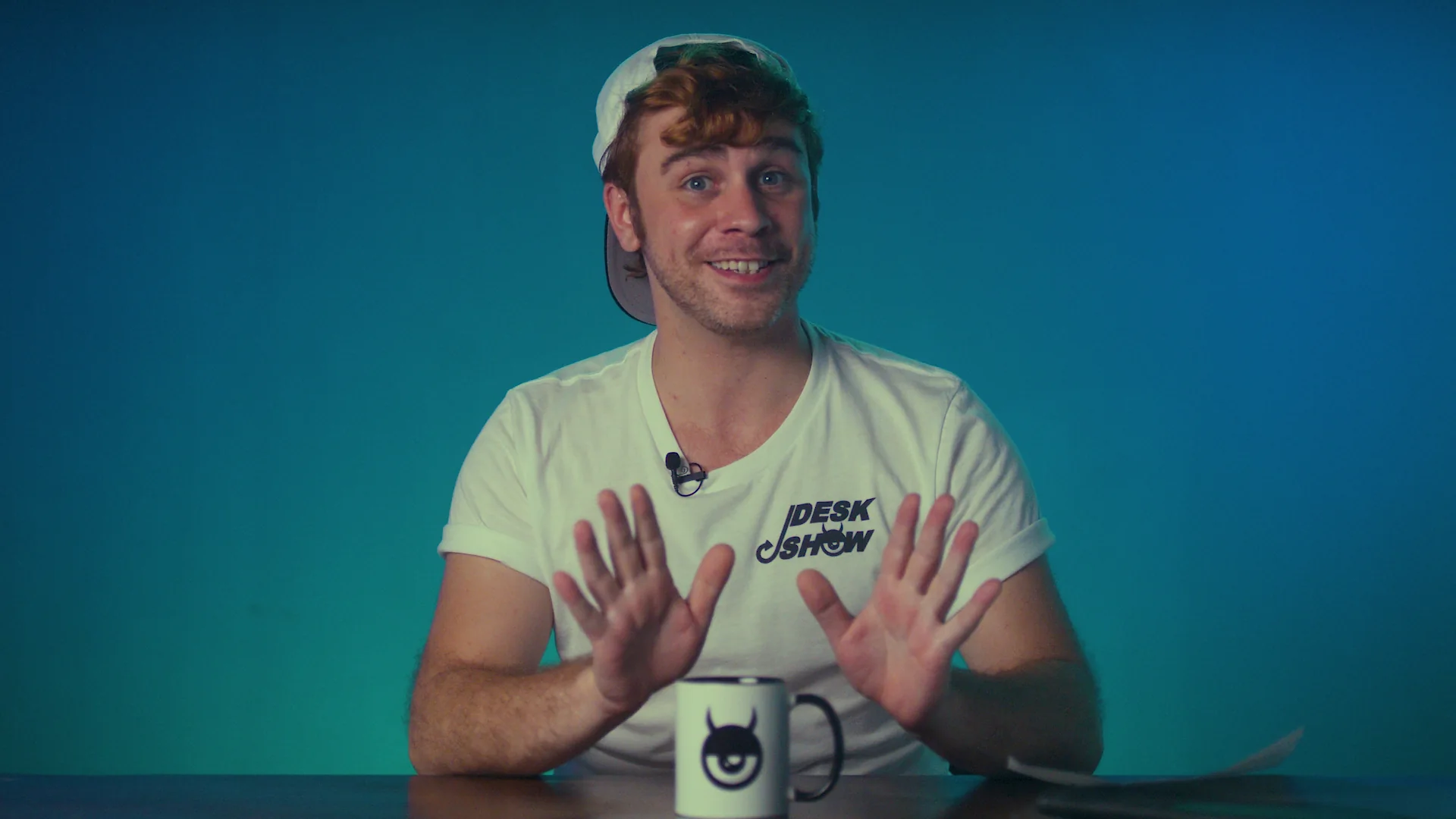 Greg, the human producer, seated at the Desk/Show desk