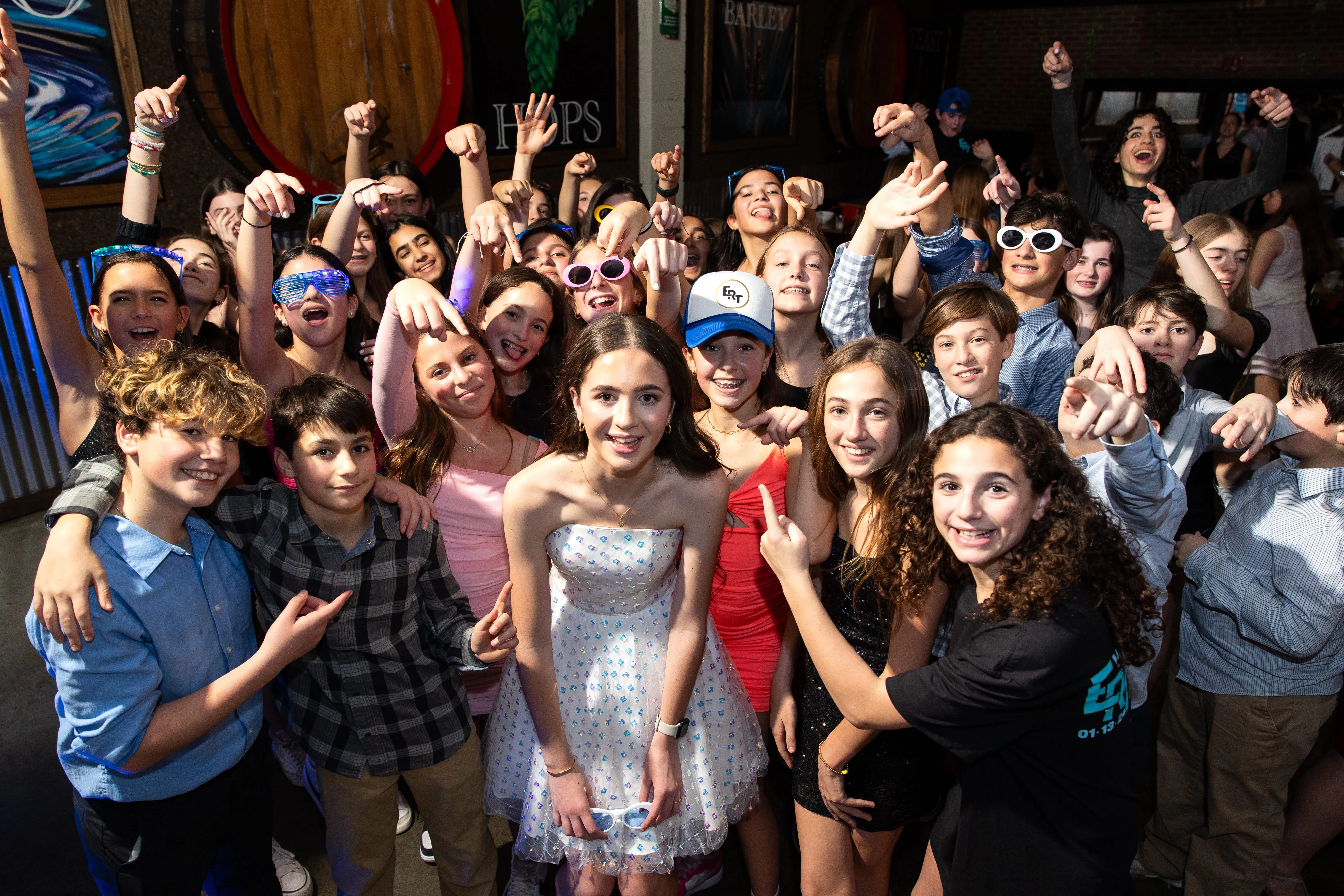 Bat Mitzvah party with kids dancing and engaging on a packed dance floor