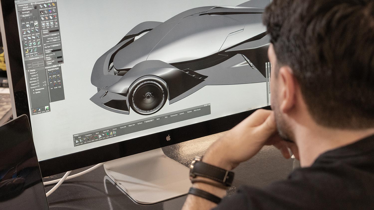 A computer screen with a 3D drawing of a car during a car design process