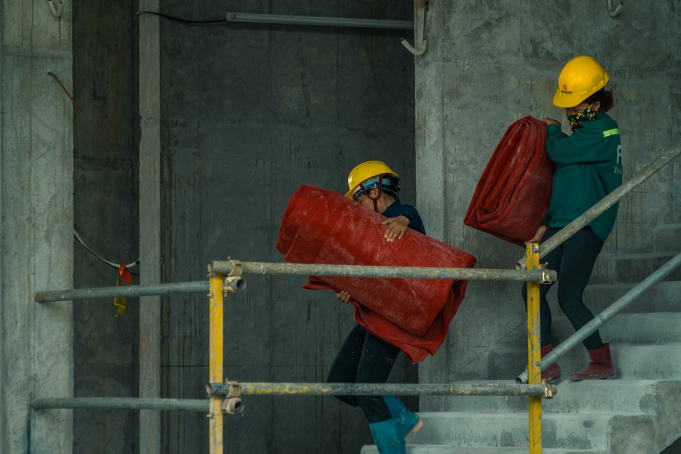 Renovation crew carrying materials on a job site