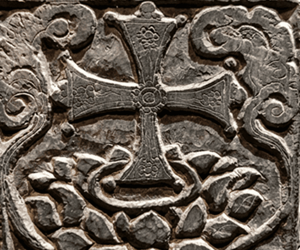 A detailed stone carving depicting a "Lotus Cross,"