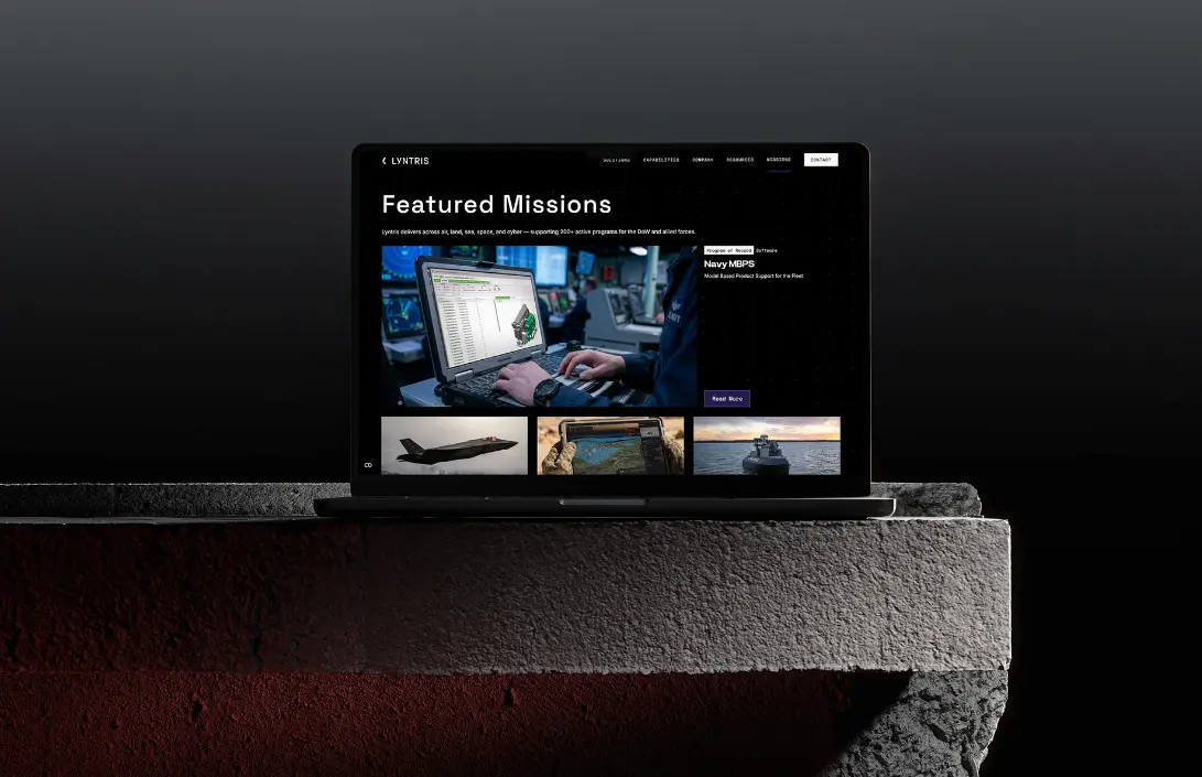 Laptop screen shows "Featured Missions" with military-themed images and a mission card layout, supporting defense tech marketing.
