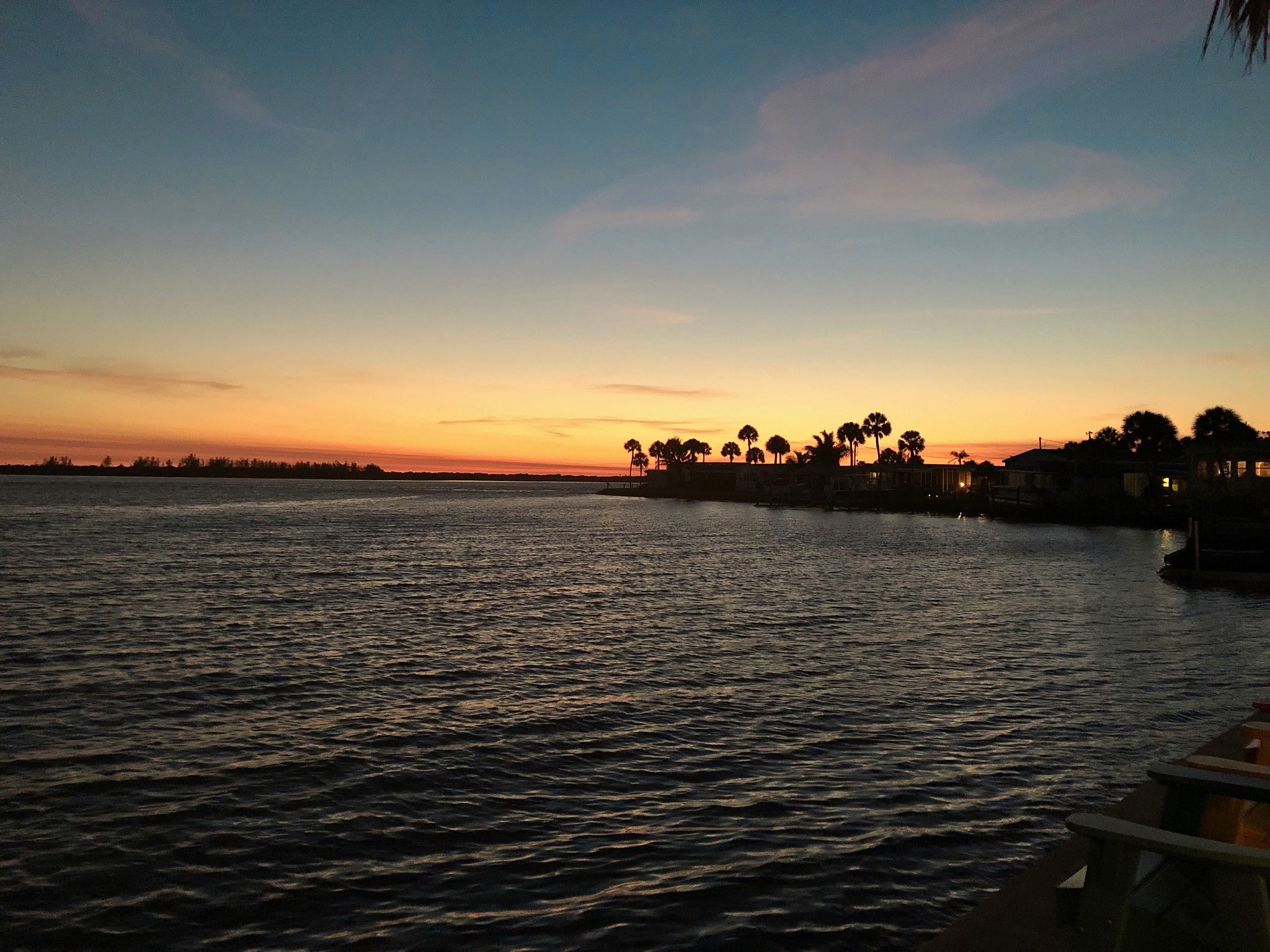 sunset with inlet and tress in background