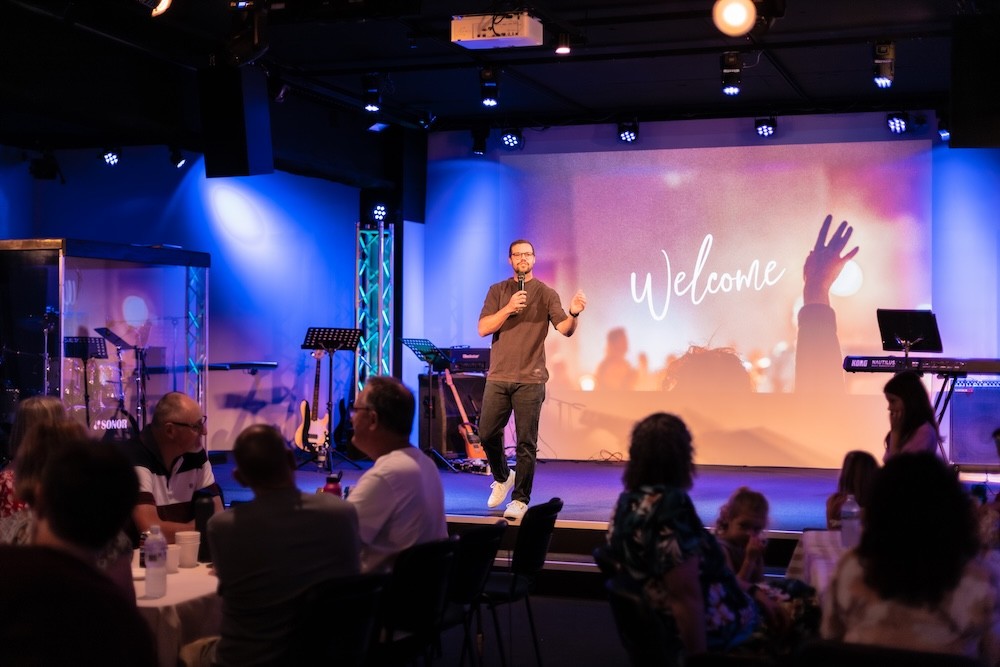 White building with red lighthouse under clear sky.