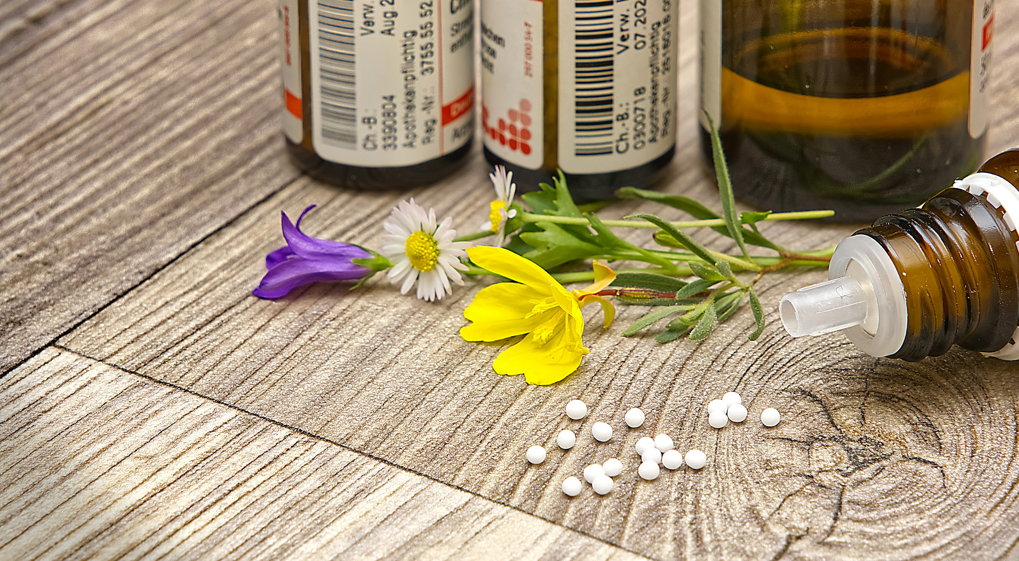 A bottle of medicine sitting on top of a wooden table