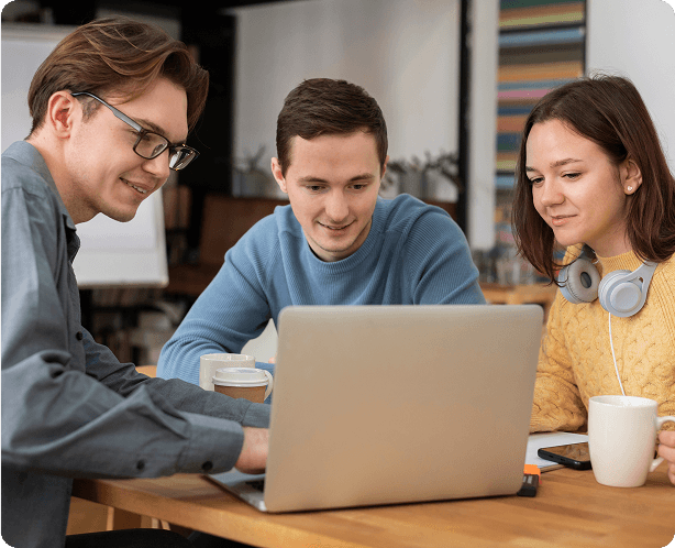 Three people working together at a laptop