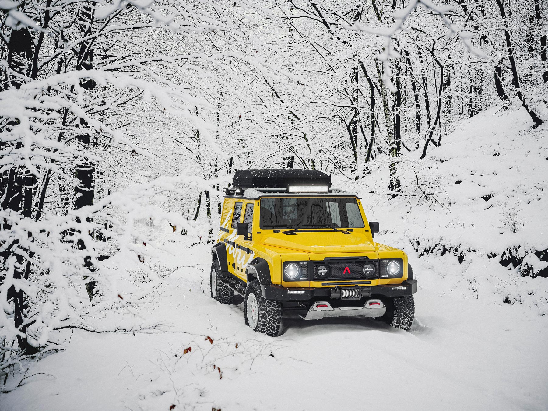 Photo of the INEOS Grenadier in a snowy forest in yellow, 3/4 front view