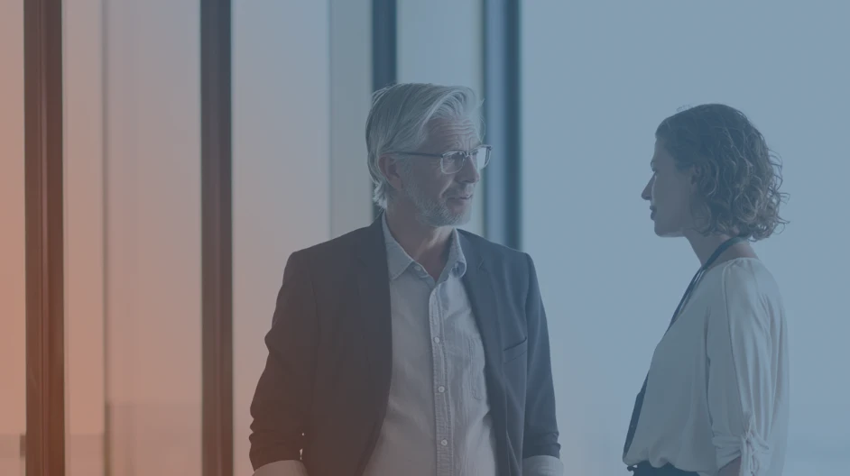 woman and man talking in office
