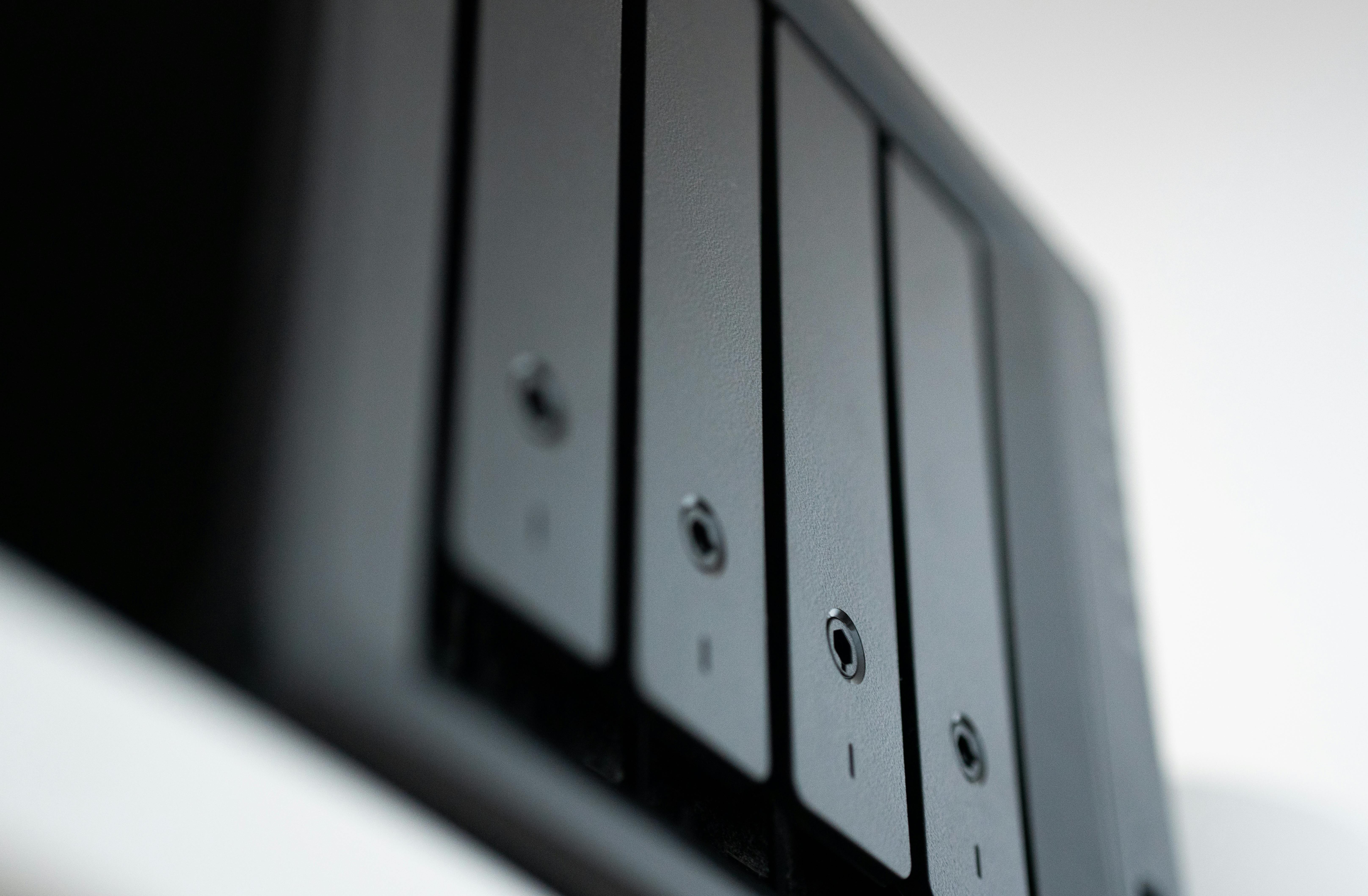 Close-up of sleek, modern hard drive bays in a data storage system.