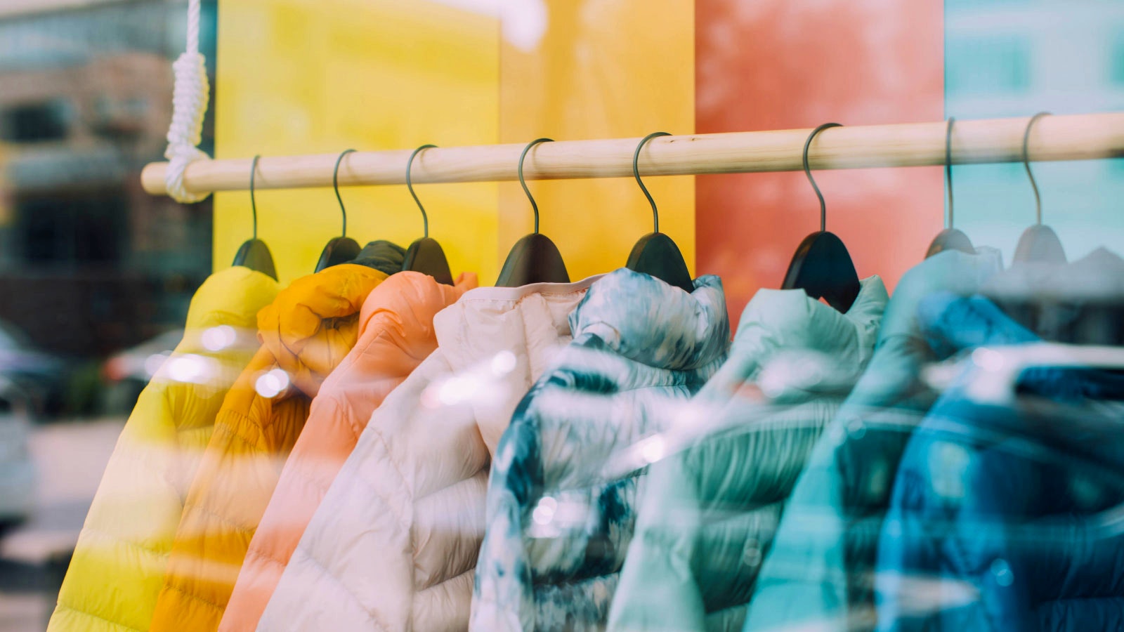 EK (voorheen Euretco) — colourful winter jackets on hangers reflected in a shop window — Soda Studio case study