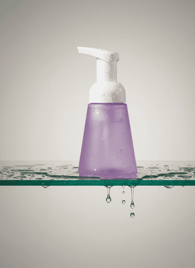 Shaving cream tube with a razor balanced on rocks.