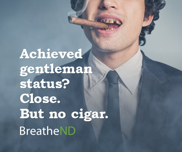 man smoking cigar with bad teeth