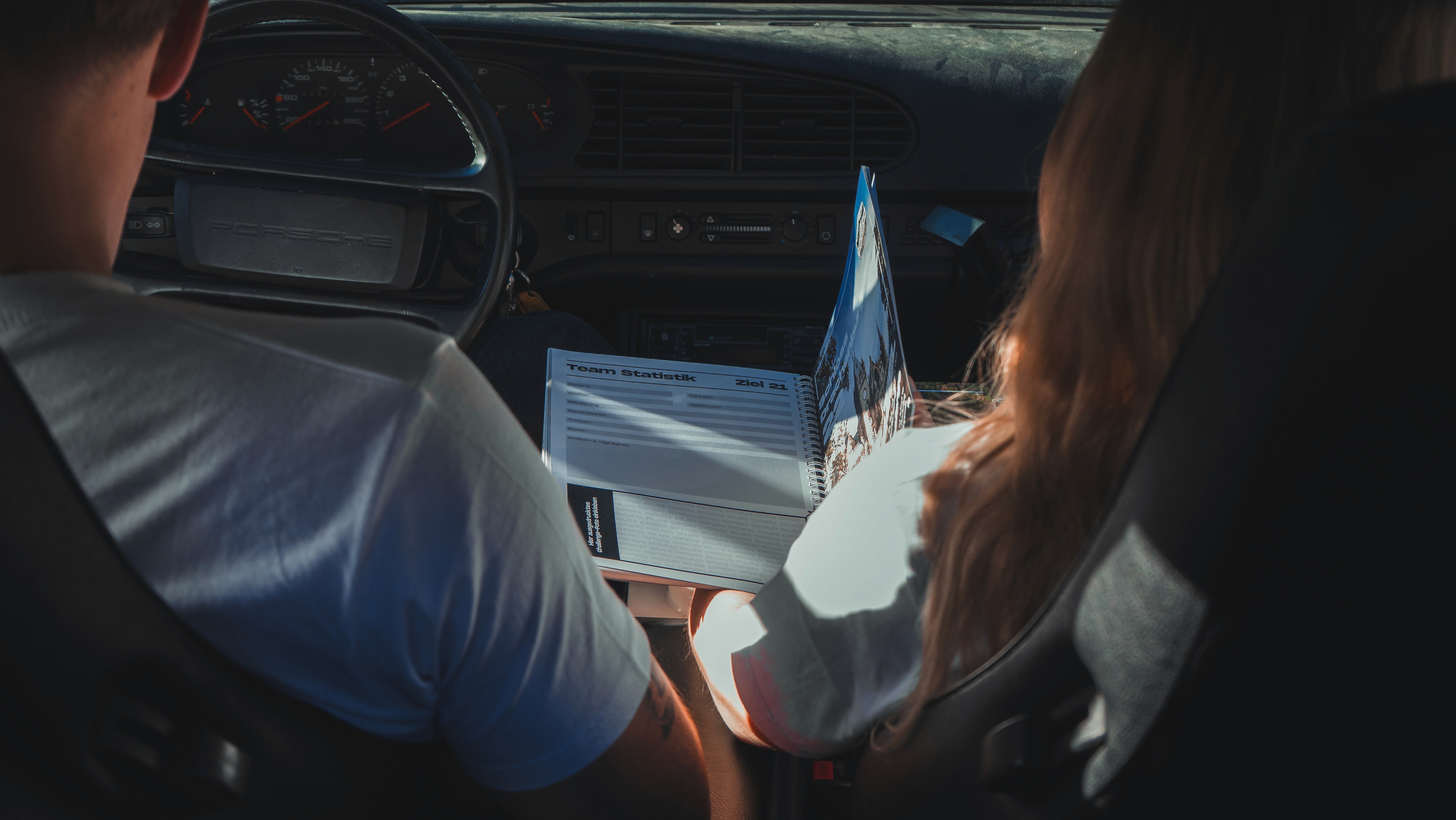 Traveler exploring narrow sandstone canyon illuminated by warm desert light in AlUla.