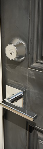 residential chrome high security lock set mounted on a black door