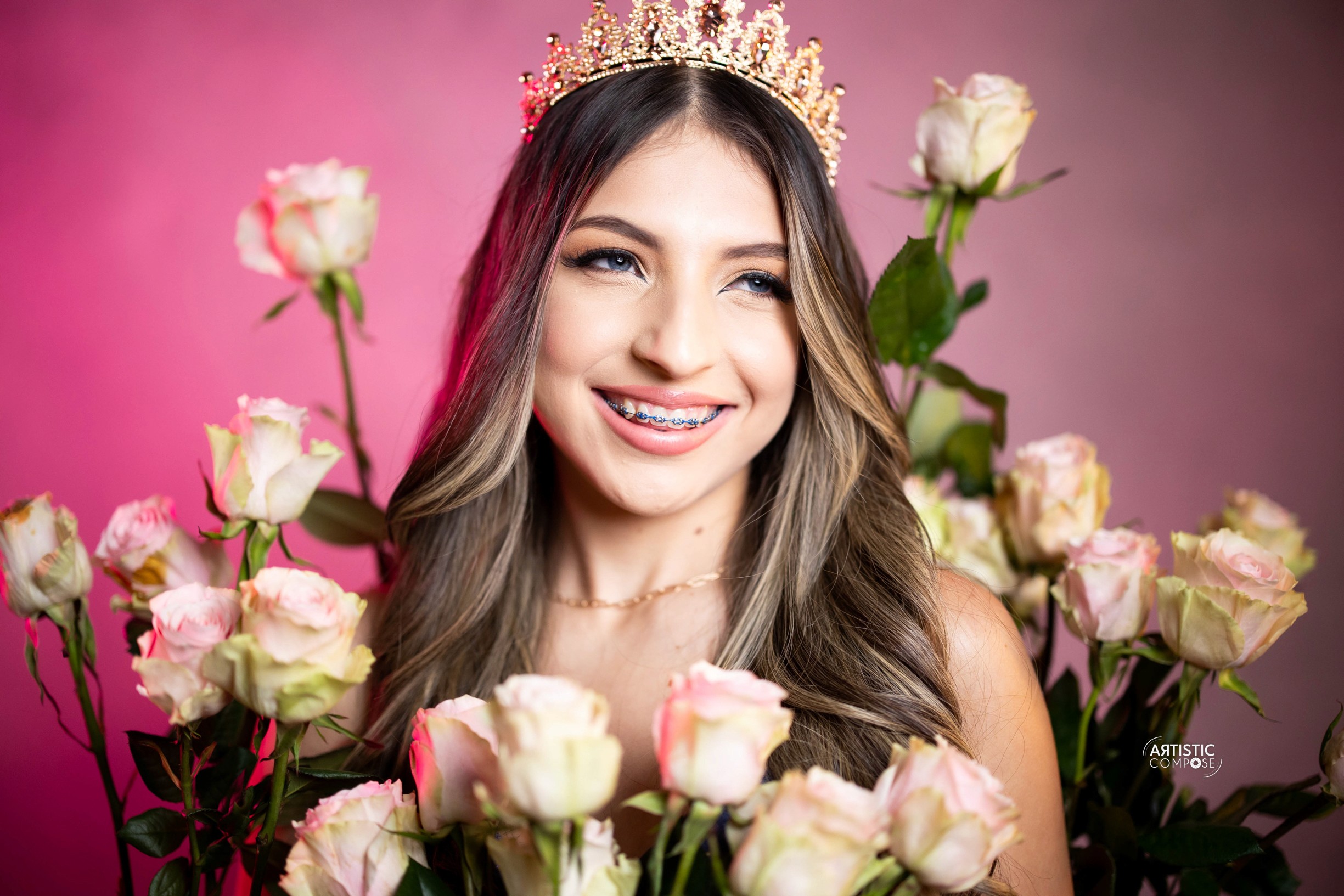 Three models standing in a wheat field, wearing beige suits.