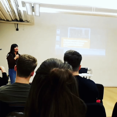 Gif of Kelly Chen digital designer presenting to a room of people 