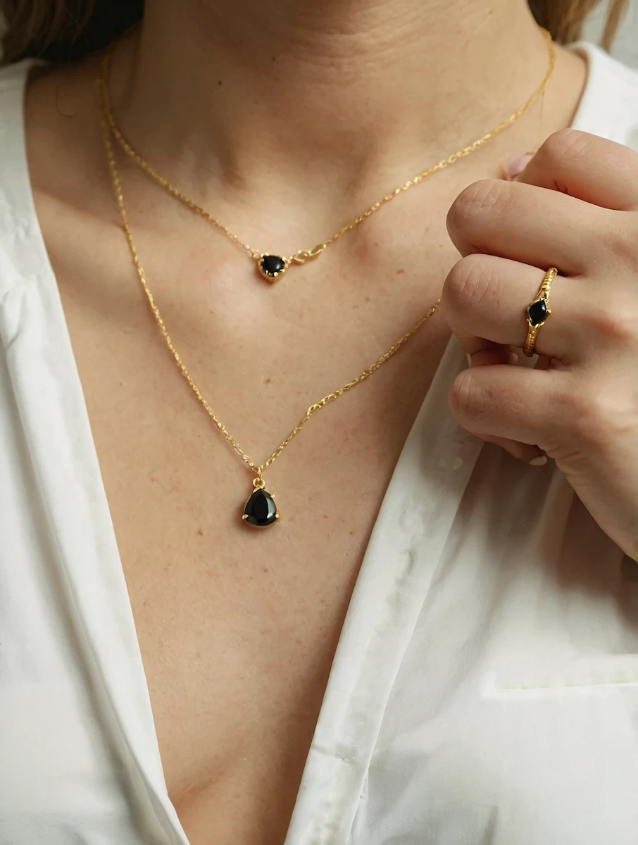 Layered gold jewelry set with black stone