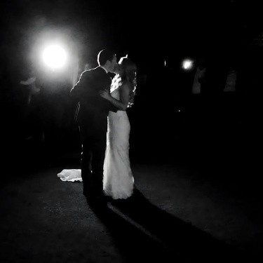 The bride and groom sharing their first dance together, surrounded by soft lighting and a romantic atmosphere, as they enjoy this special moment.