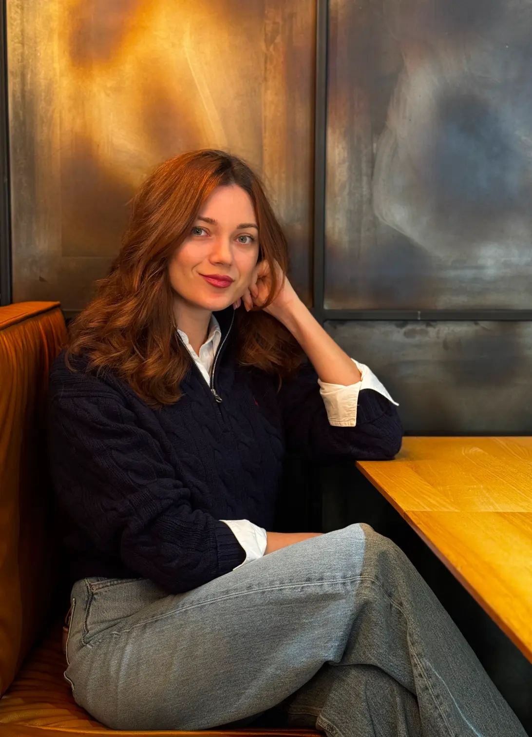 A smiling handsome woman in a cafe