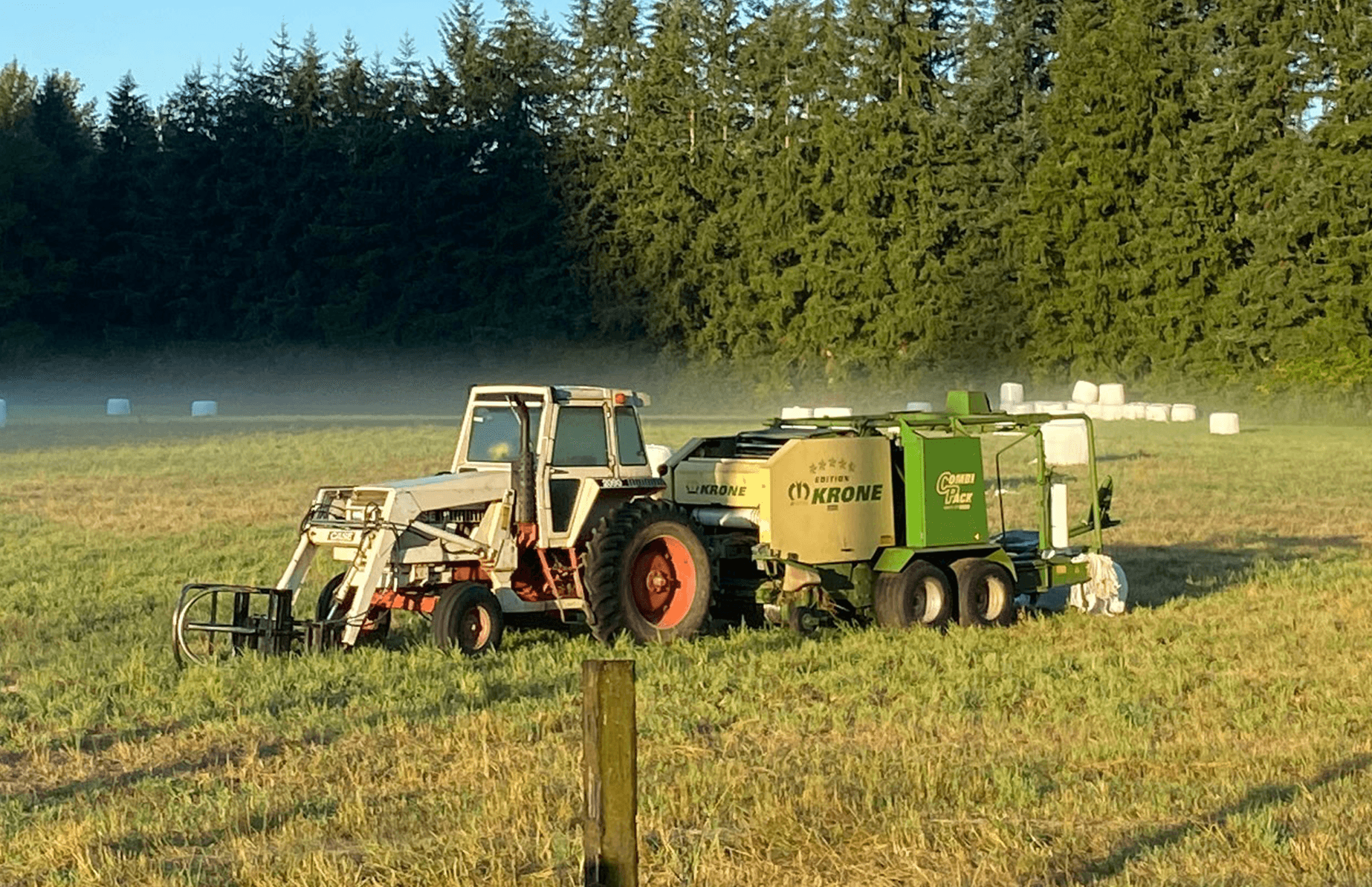 Farming equipment operating in an open field during agricultural work.