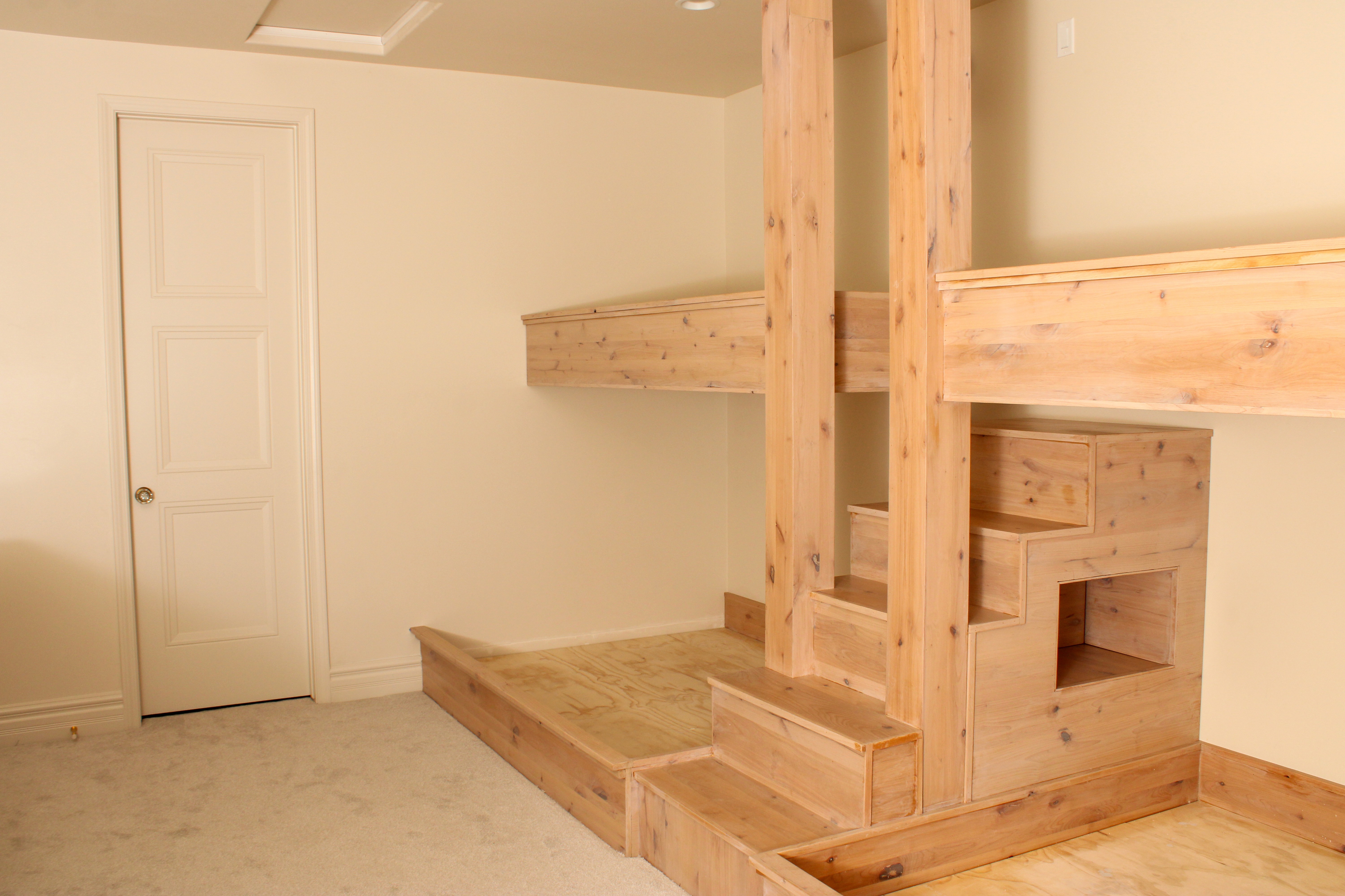Bunk room with built-in bunks and practical storage in a custom home in St. George, Utah.