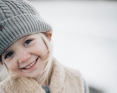 Kid with woollen cap smiling