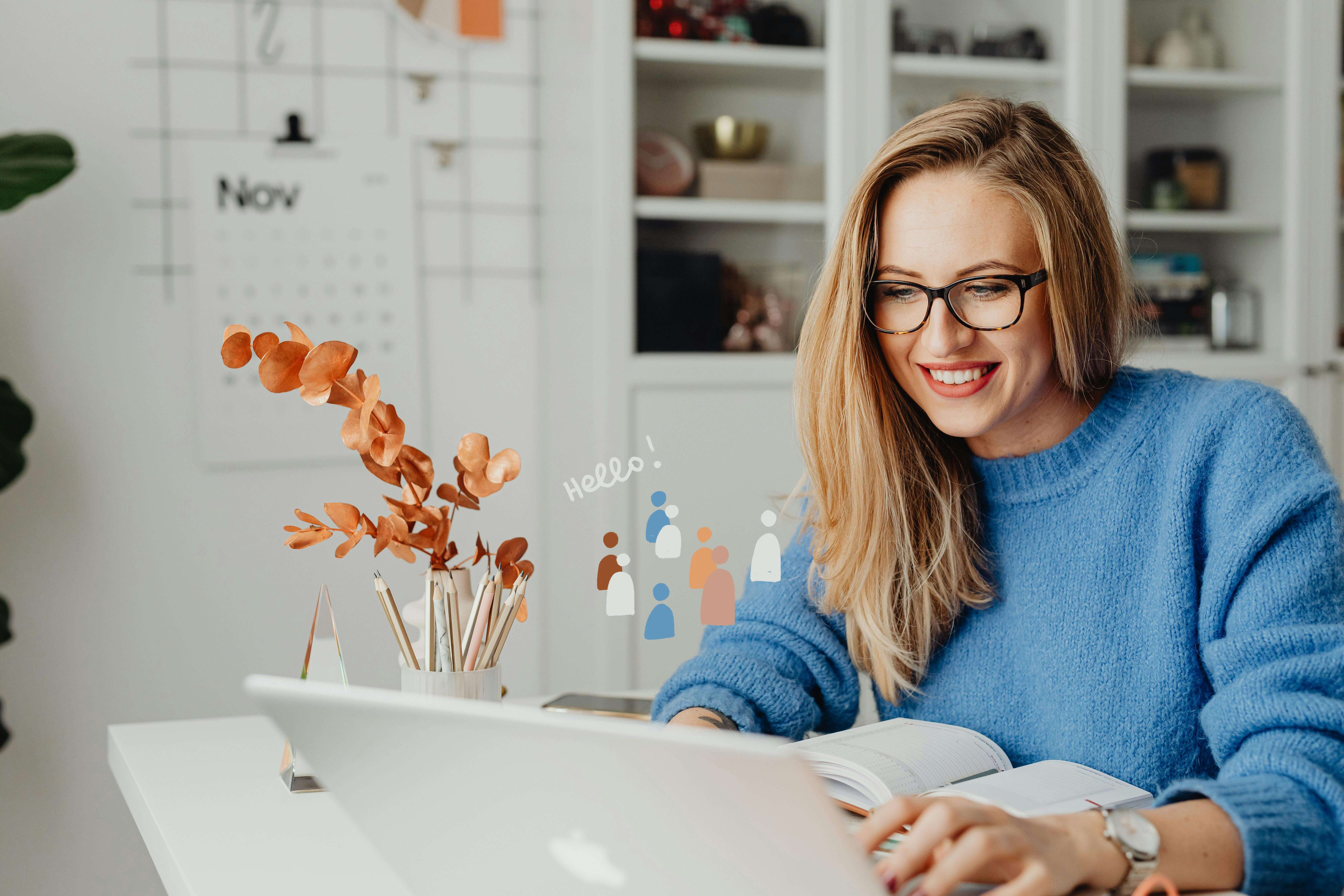 A woman using a laptop while smiling