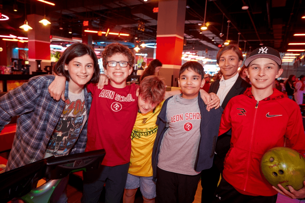 a group of children sitting at desks in a classroom