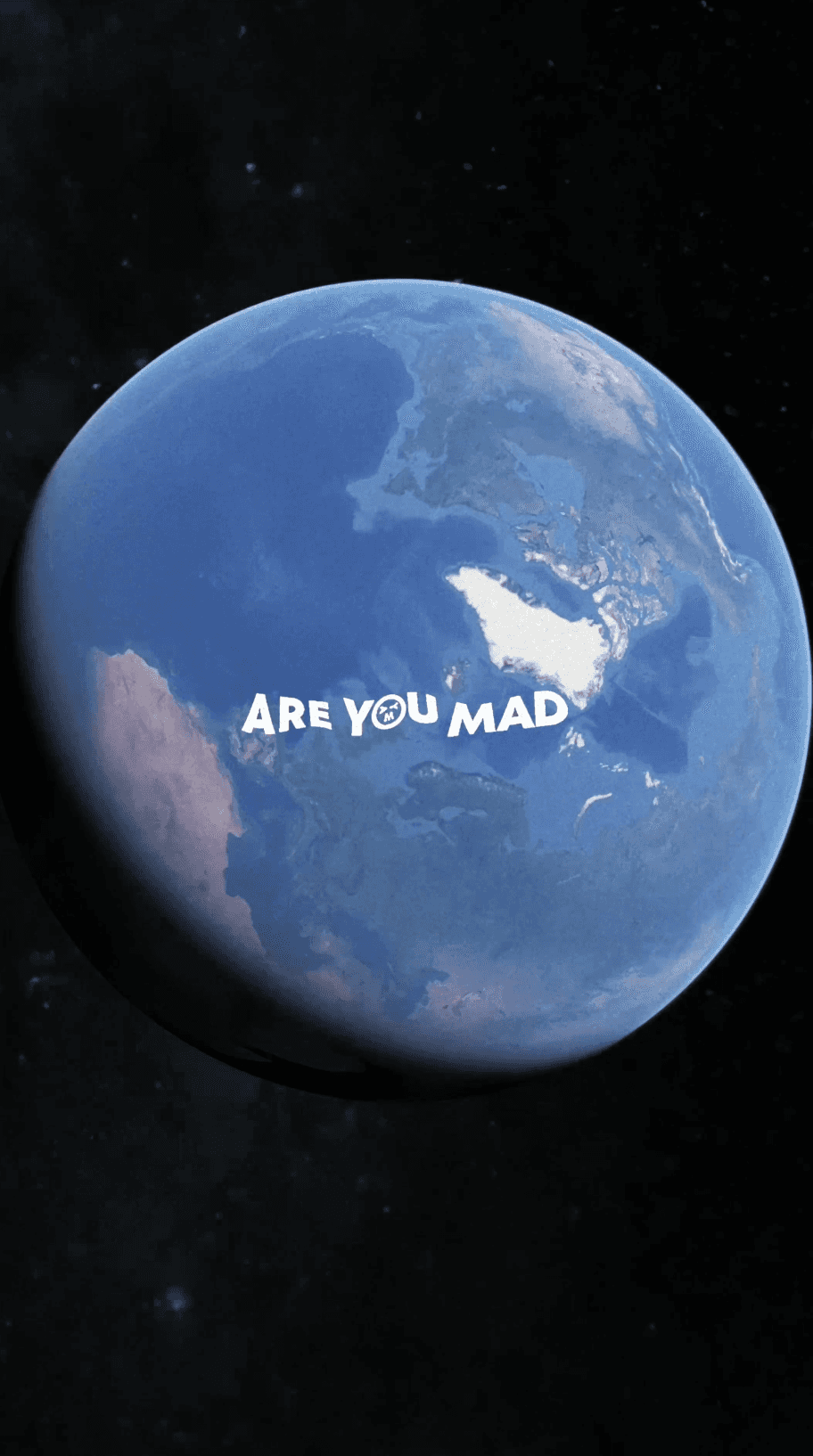 Bride sitting on ground against wall, groom standing nearby