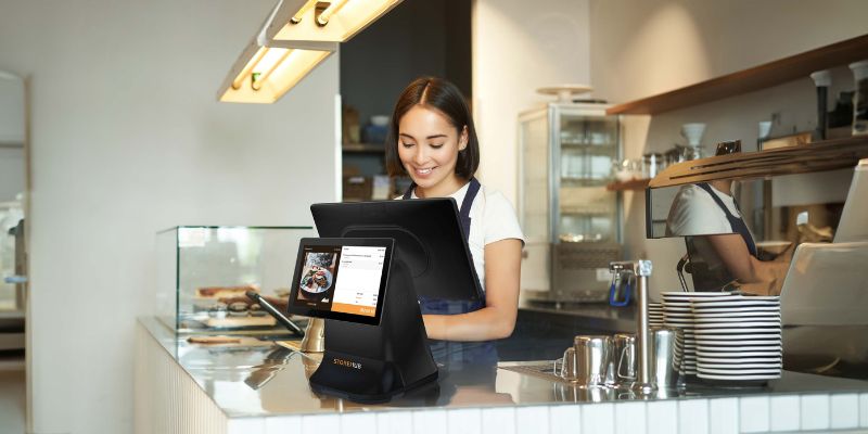 A female restaurant owner with a POS system