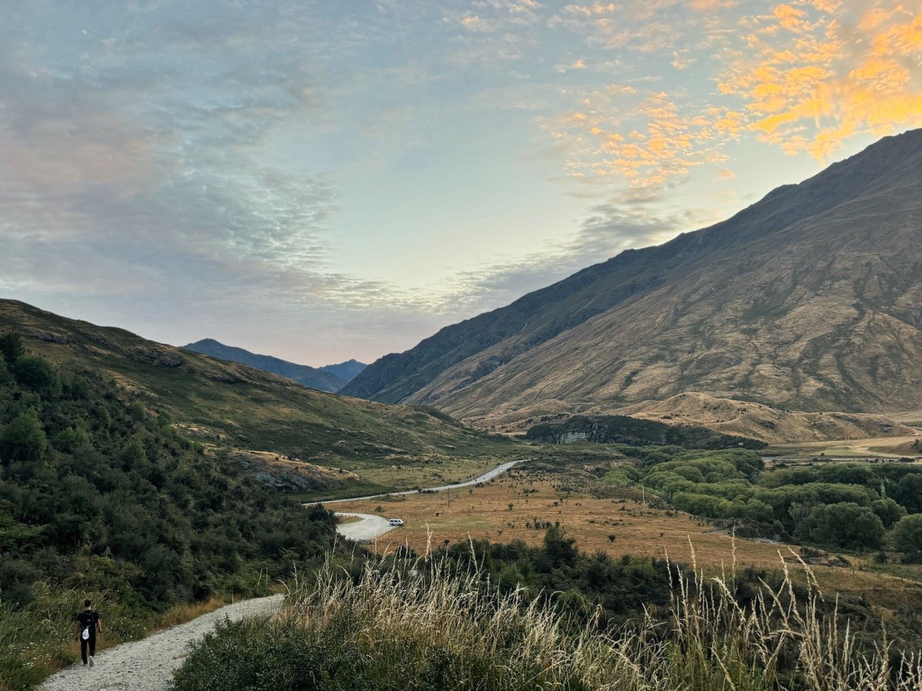 Man walking a long road towards a huge mountain