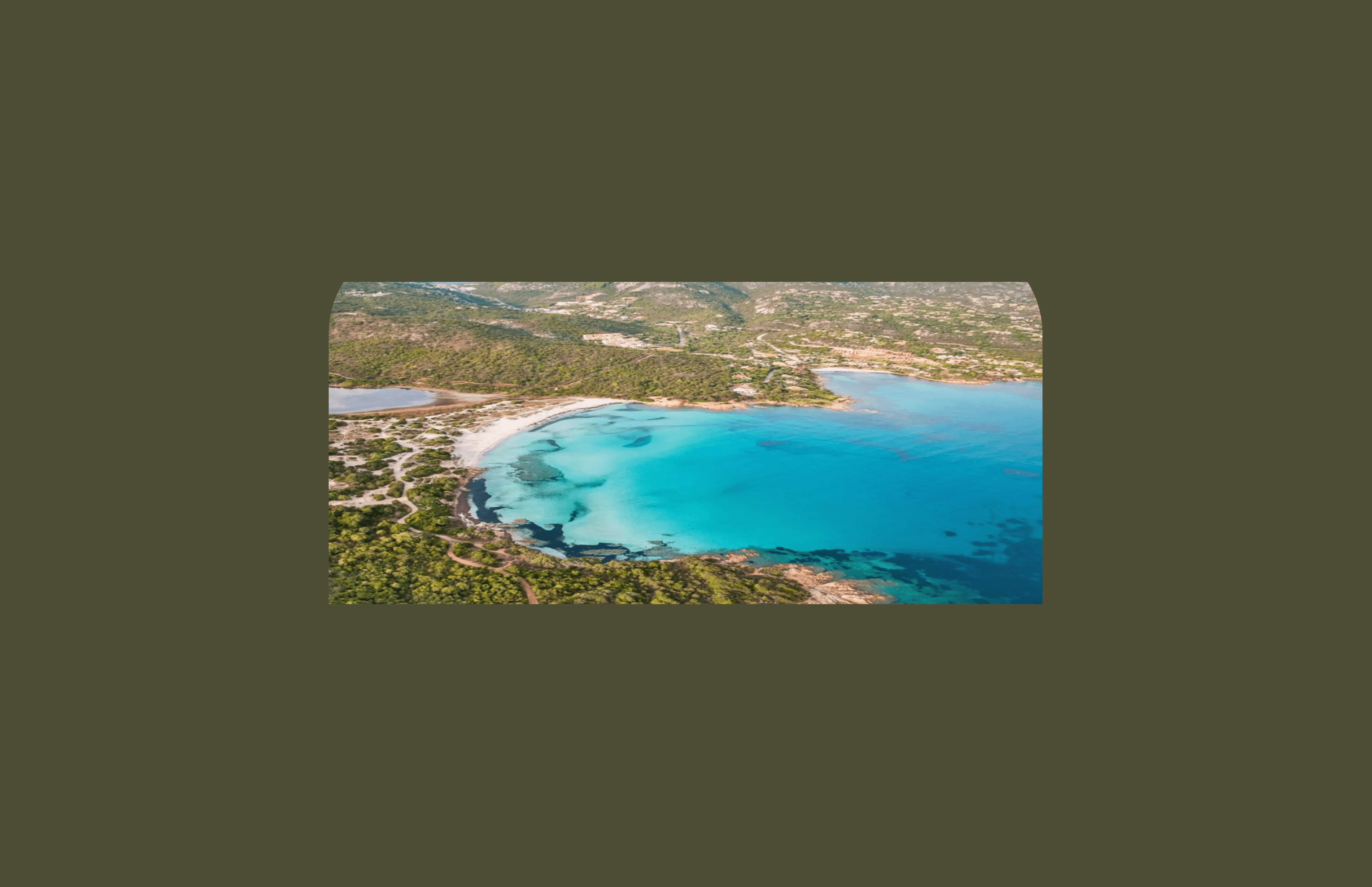 Aerial view of the Sardinian coastline with turquoise Mediterranean water and white sand beaches, illustrating why the island is popular with long-term residents and digital nomads.