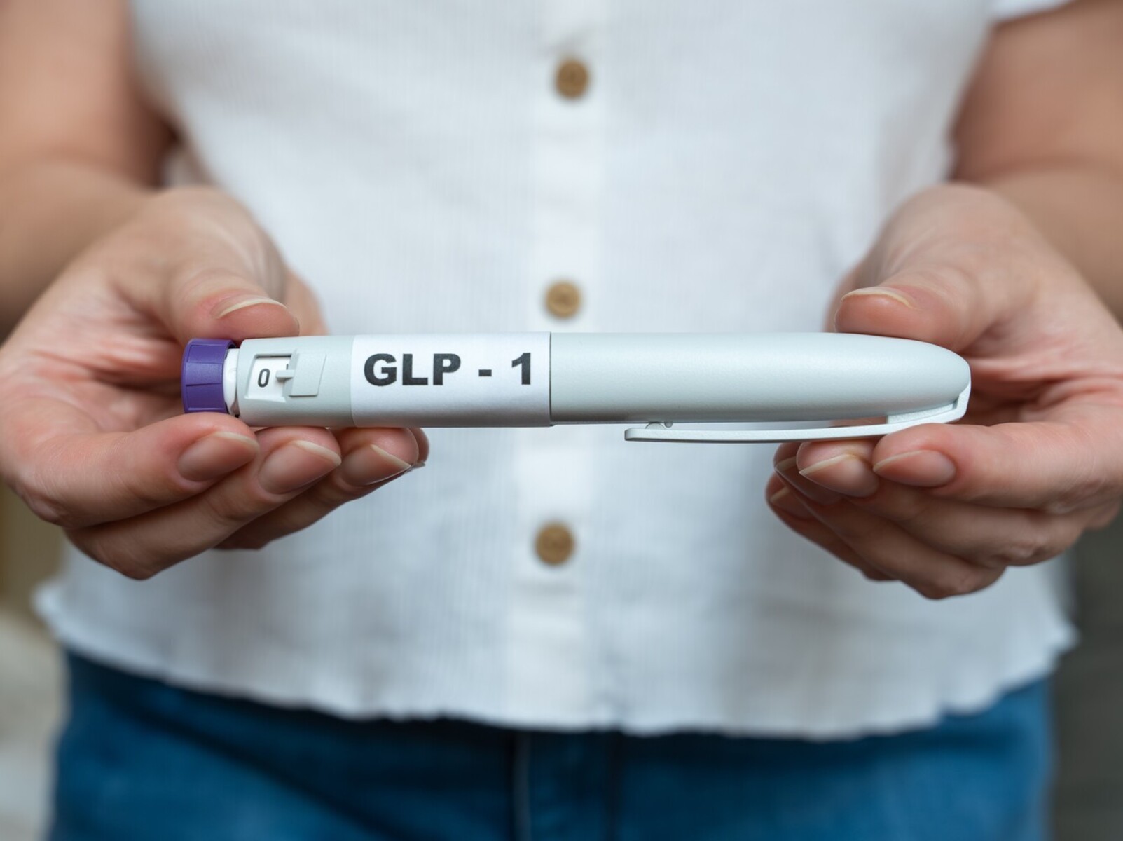 woman holding out a GLP-1 injection instead of choosing the most effective weight loss pills