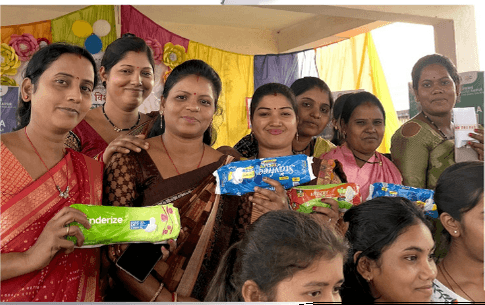 Group of women receiving support materials, representing community empowerment and outreach