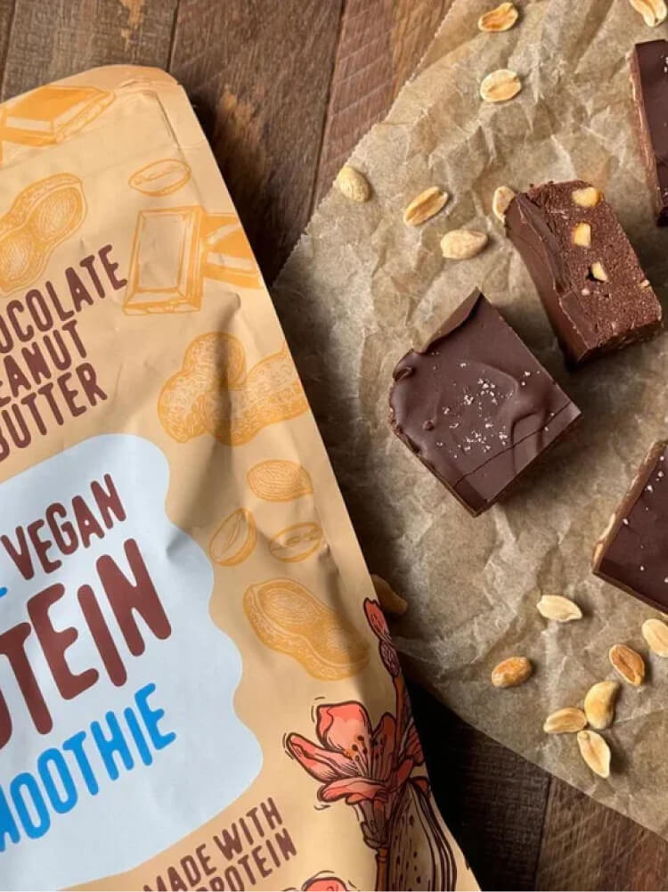 Two toddlers in puffy jackets playing in the snow.