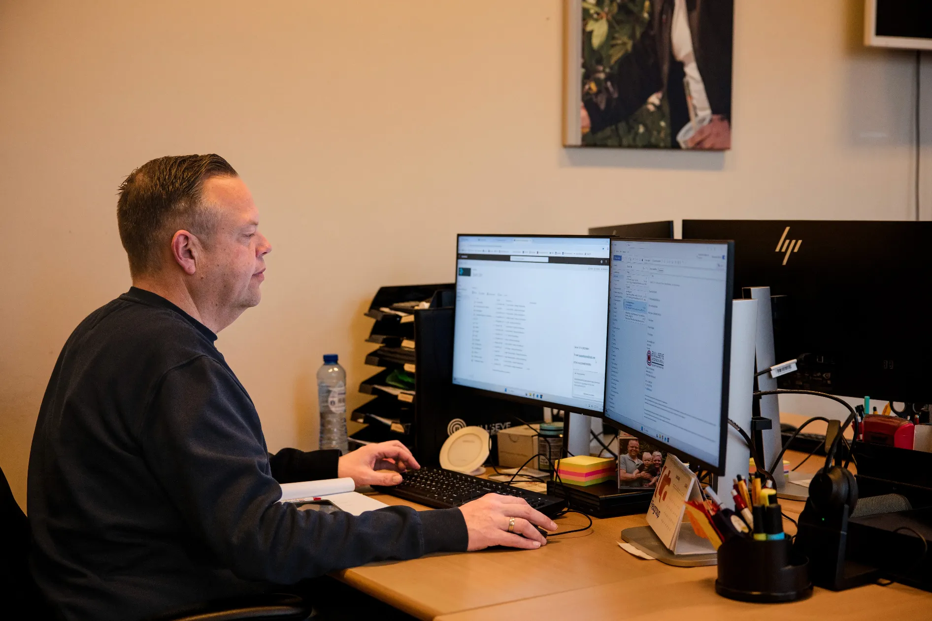 man in green and black plaid long sleeve shirt holding red and black cordless hand drill
