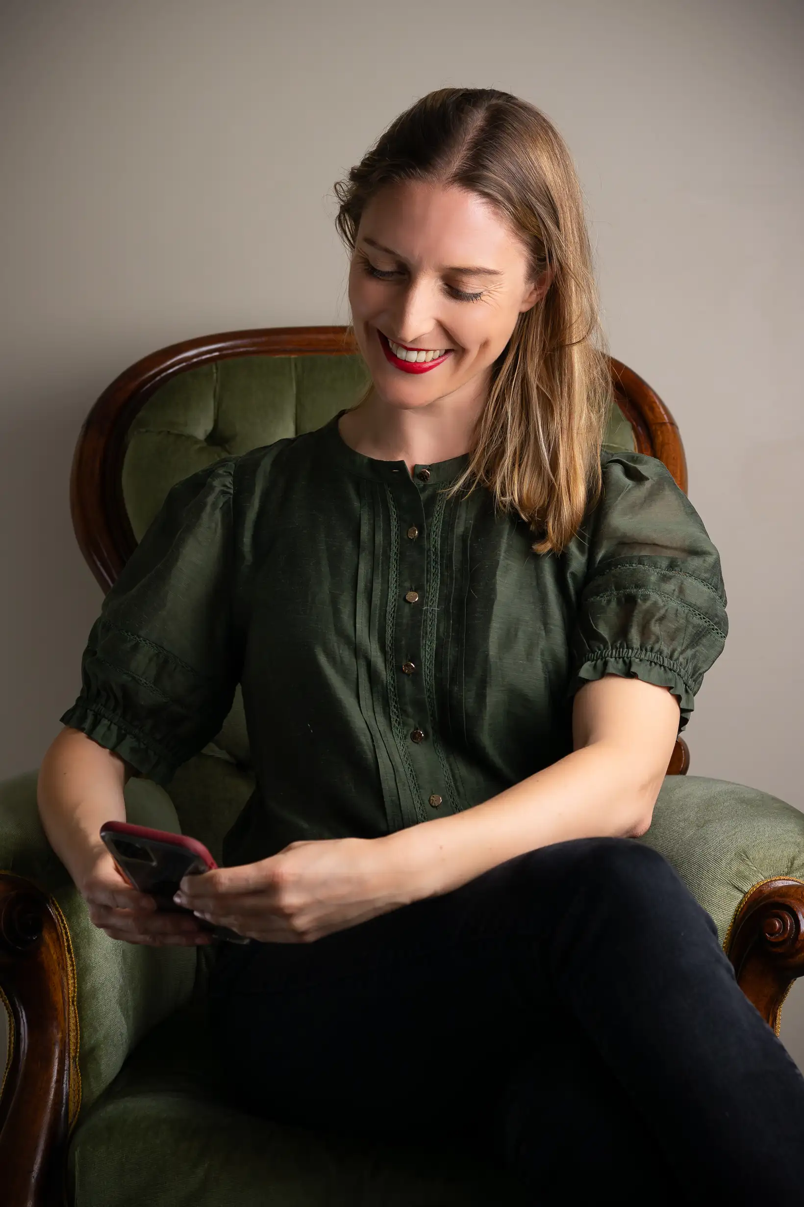 Melanie looking at her phone helping a client with marketing