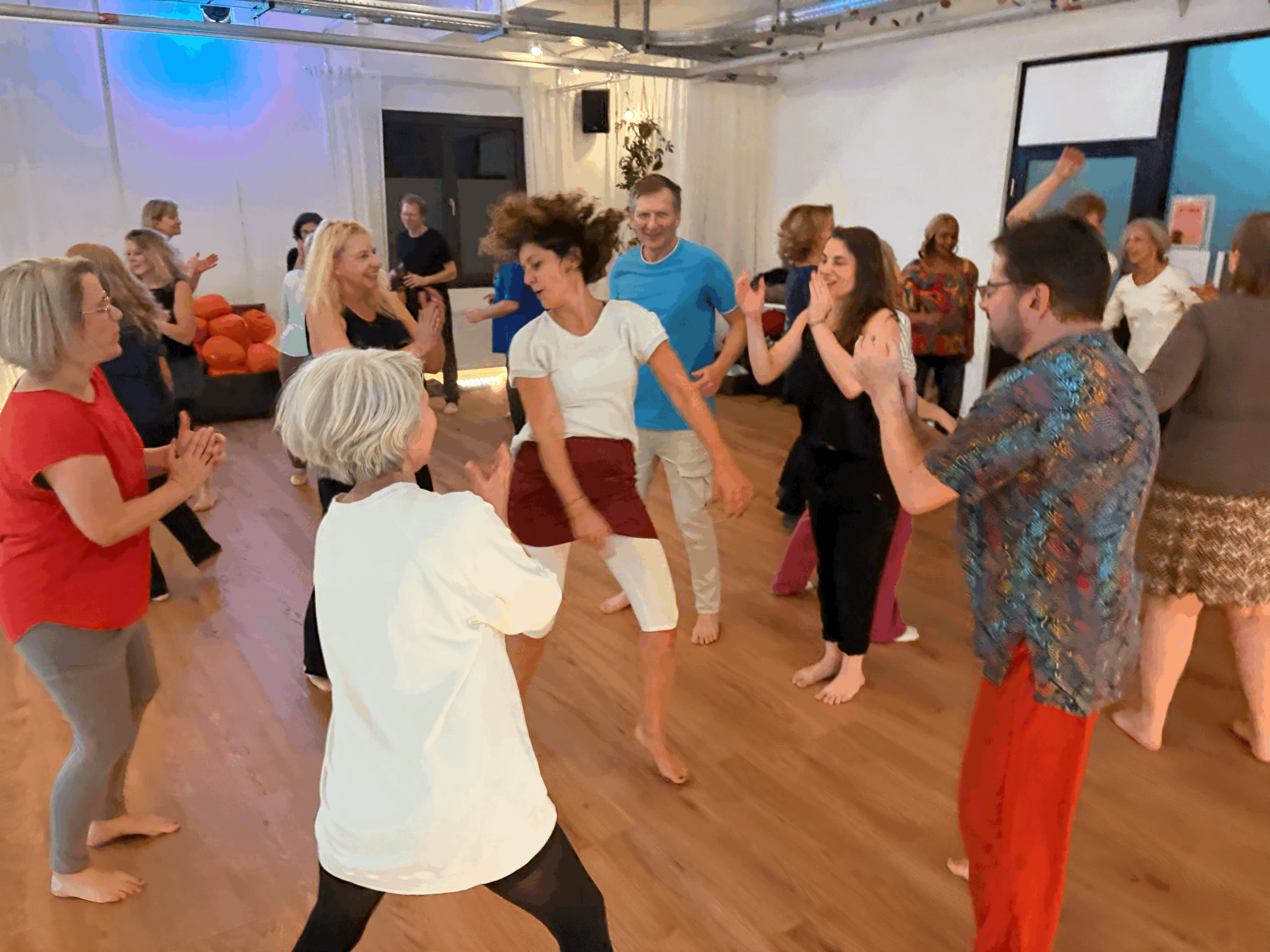 A serene spa setting with two lounge chairs beside a warm, reflective pool and soft, natural lighting.