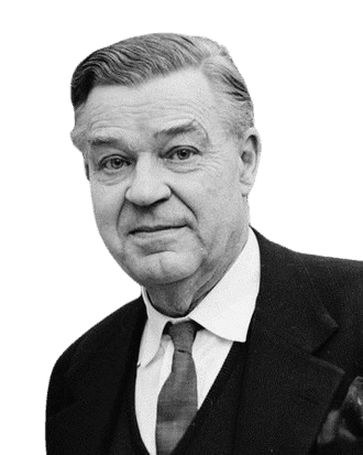 Black and white portrait of an older man with neatly combed hair, dressed in a suit, sweater, and tie. He has a gentle, reserved smile and a calm expression, conveying warmth and dignity. The formal attire and composed demeanor suggest a professional or scholarly background.