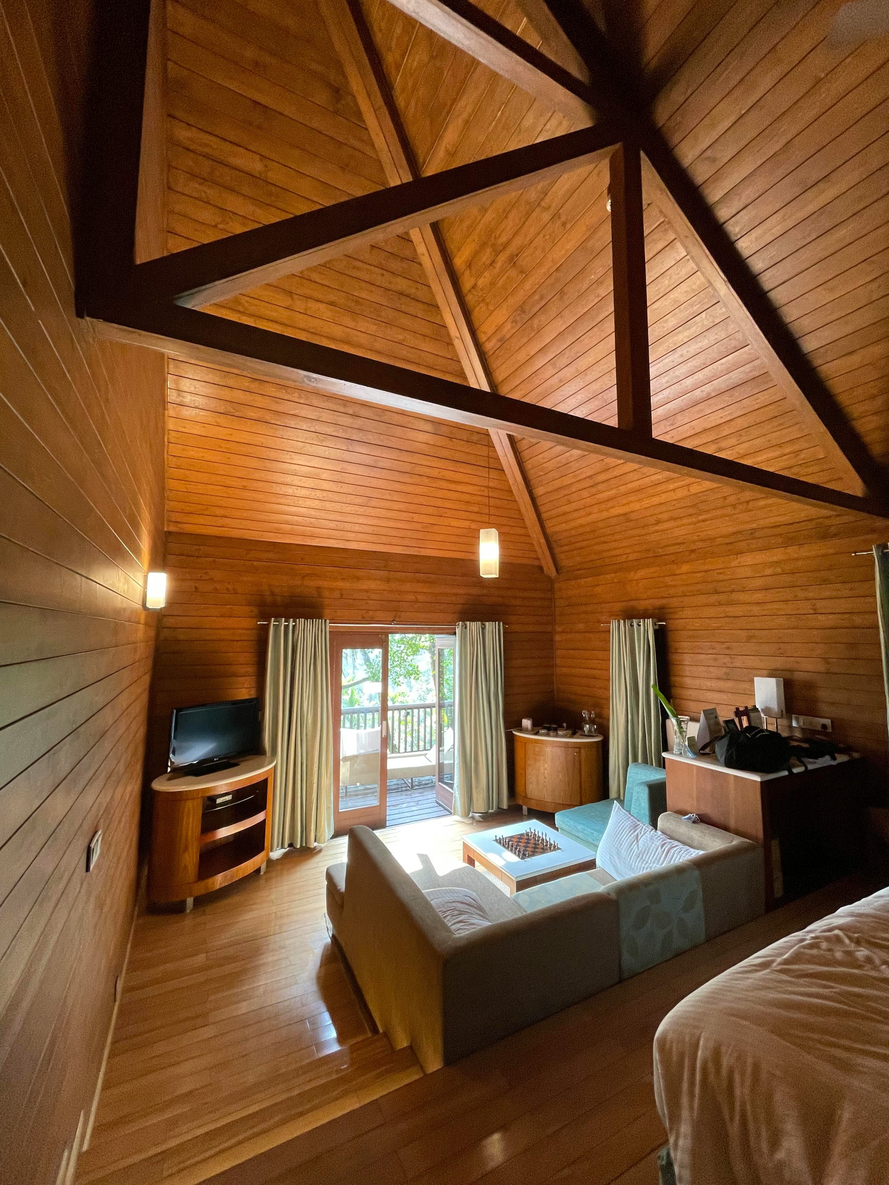 Cozy living room with exposed wooden beams and comfortable seating.