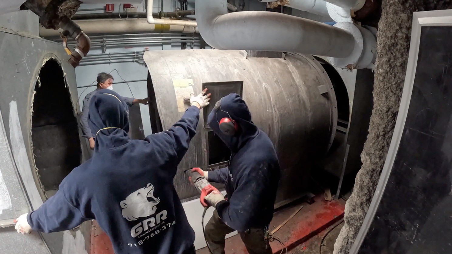 GRR Cooling Experts technicians removing legacy return fan during hospital retrofit in BronxCare, NYC