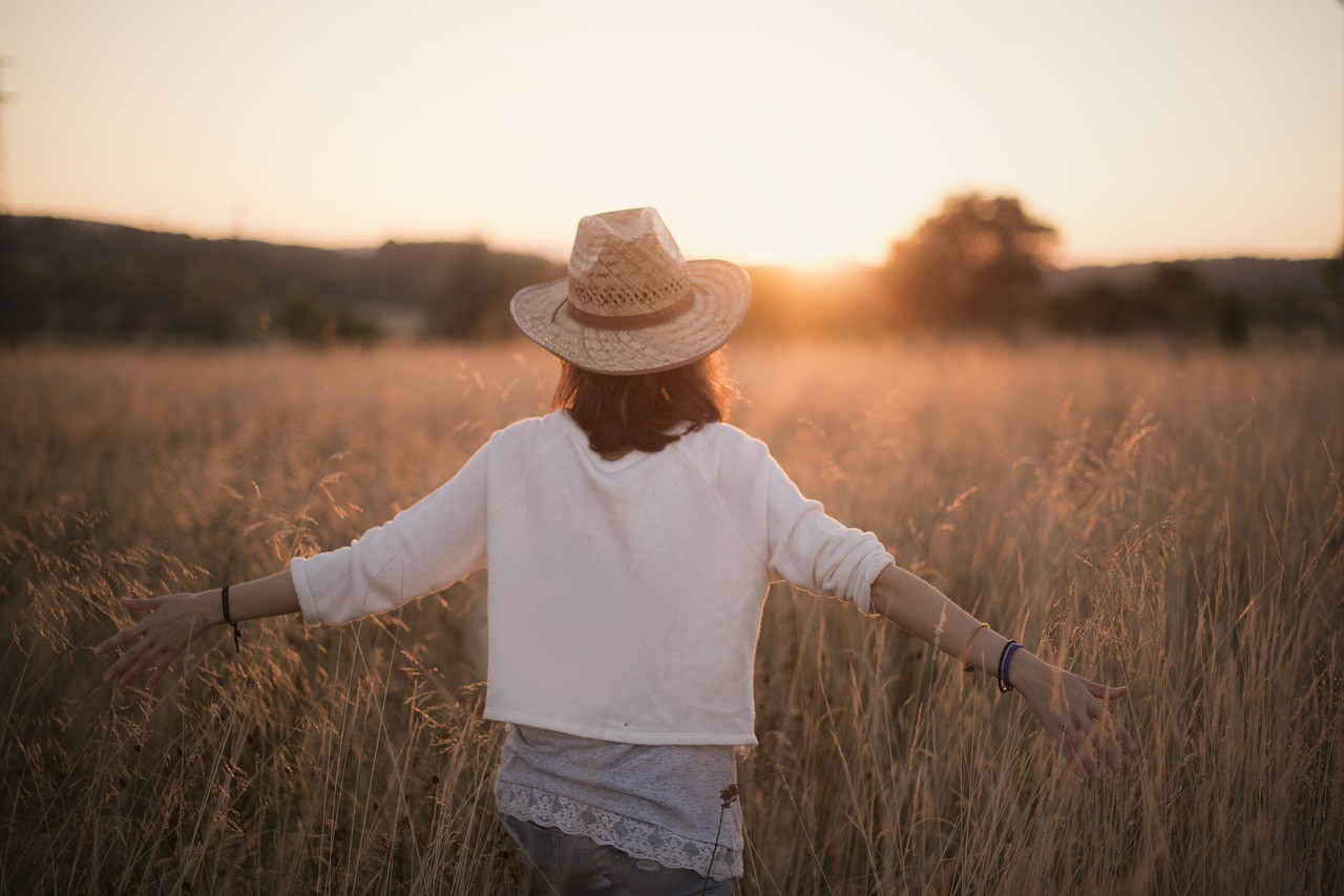 Woman walking in field of wheet like Gladiator