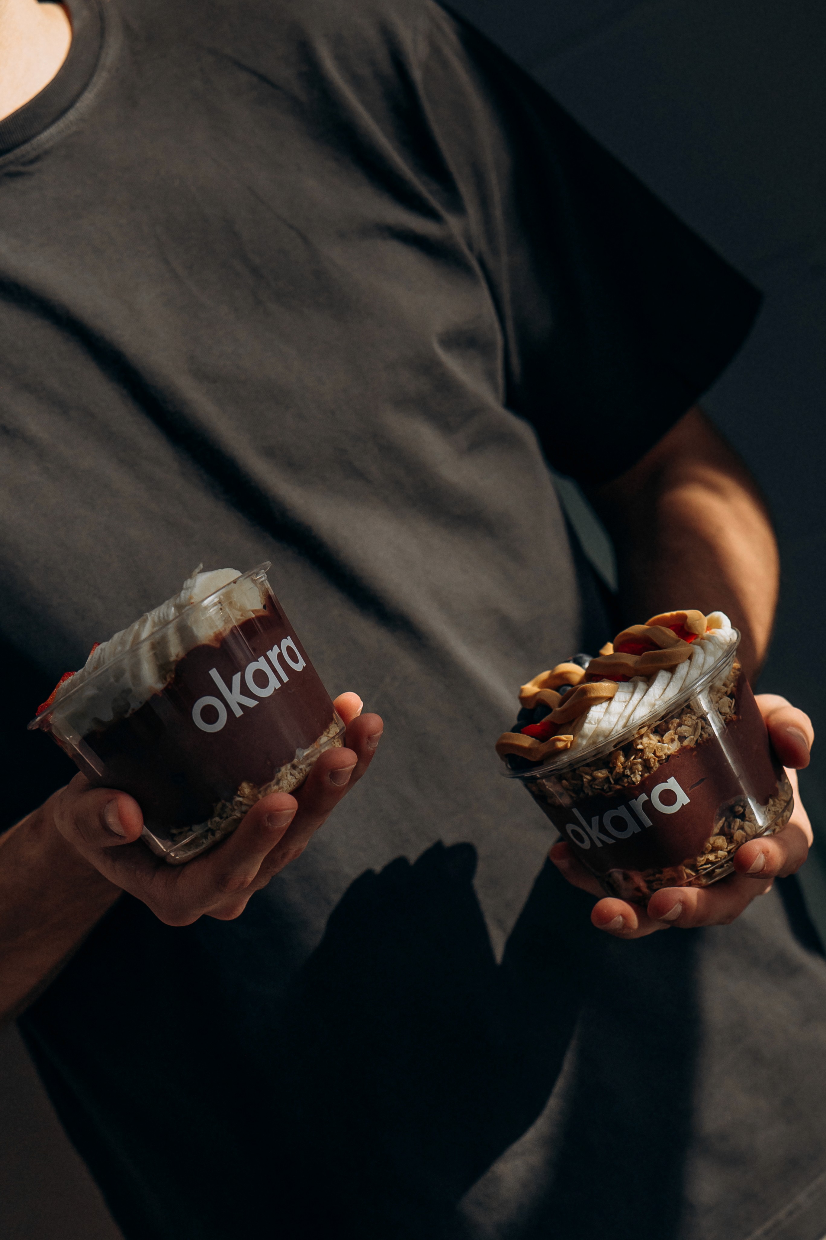 woman holding a phone and man looking at the phone. both are smiling