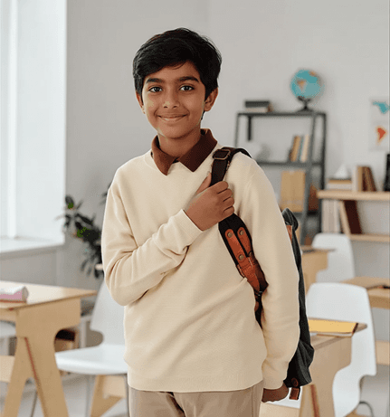 A student stands with a backpack on, ready for school