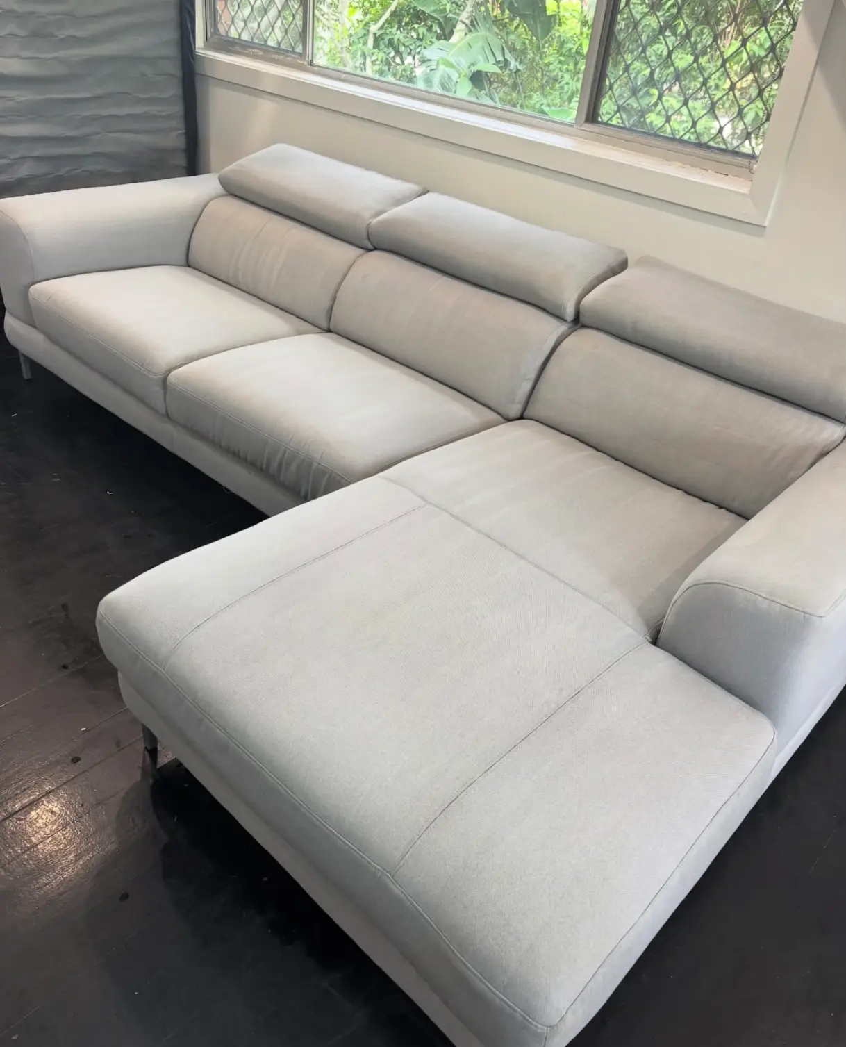 A spotless and refreshed light grey sectional sofa after a professional upholstery cleaning add-on service.