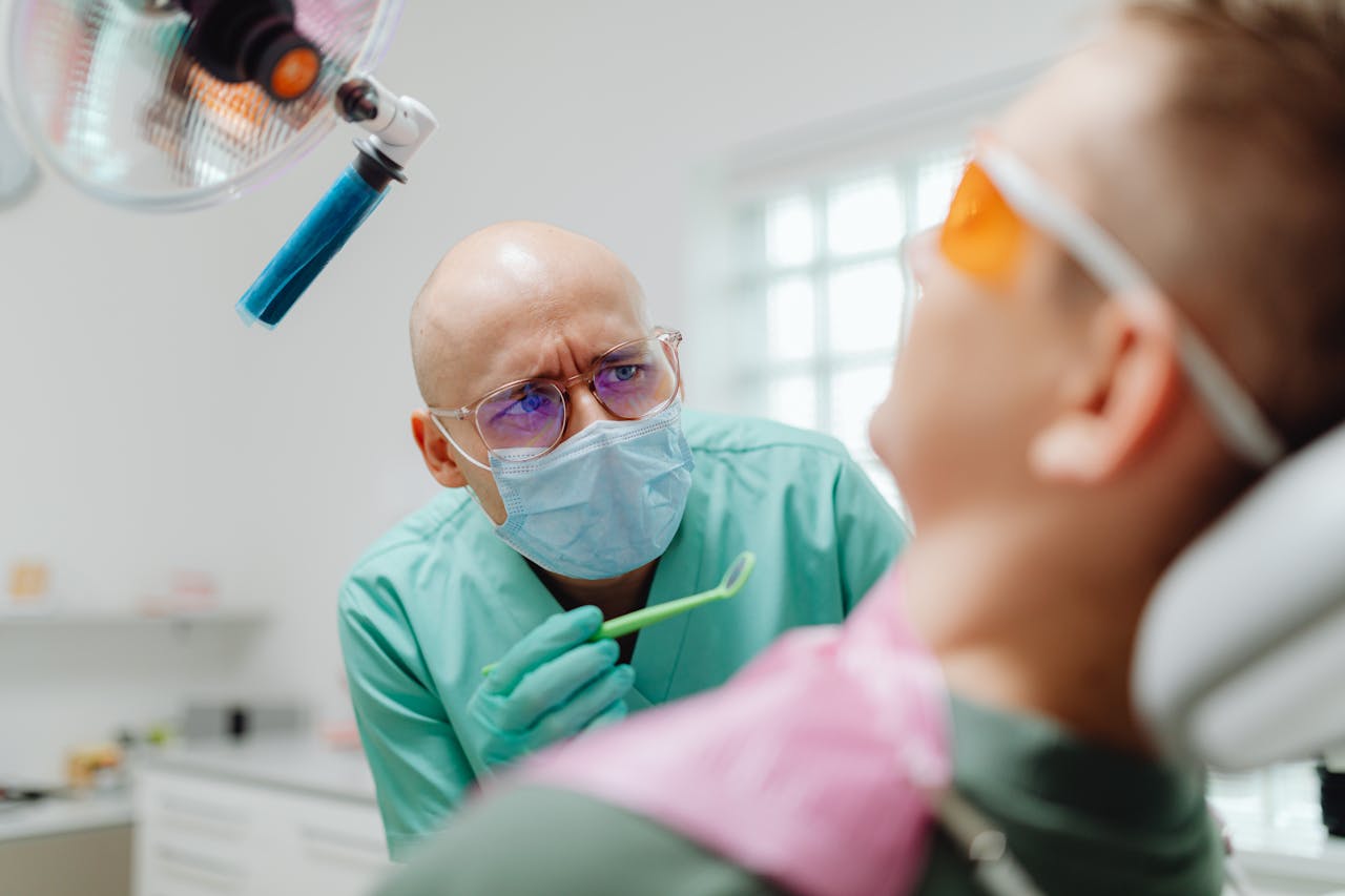 A dental hygienist treating his patient