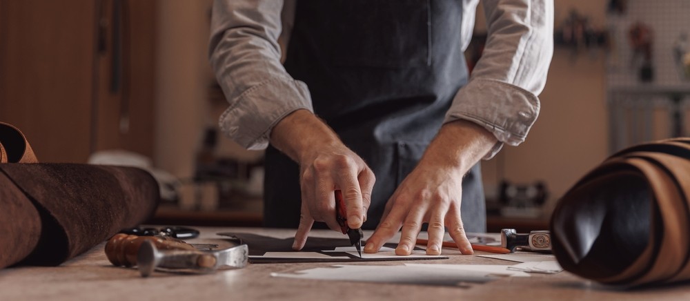 person sitting on grass and using phone