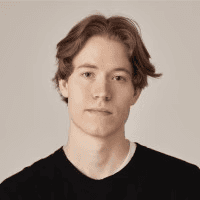 A man works on a laptop in an office.