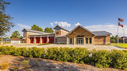 A fast black sports car races down the highway.