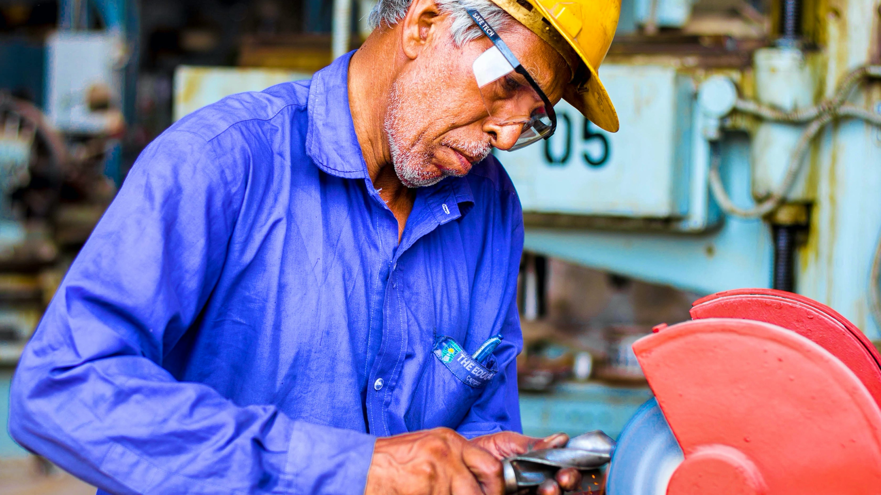 Luba — person in a blue work jacket wearing a yellow helmet working in a workshop environment — Soda Studio case study